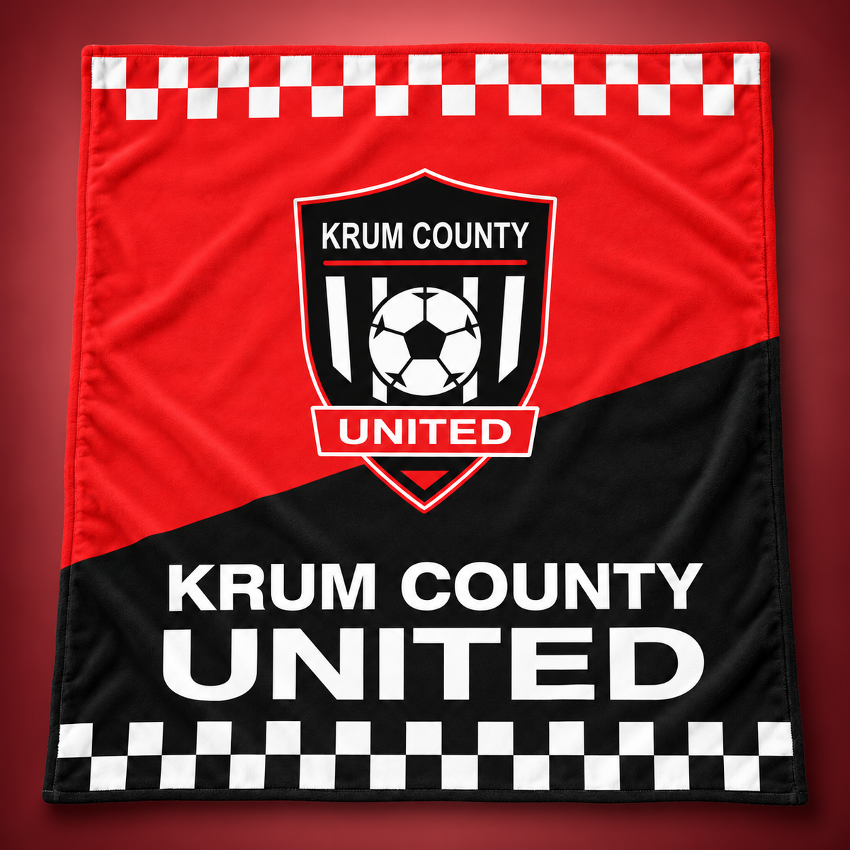Red and black Krum County United stadium blanket with an oversized crest and white checker borders.