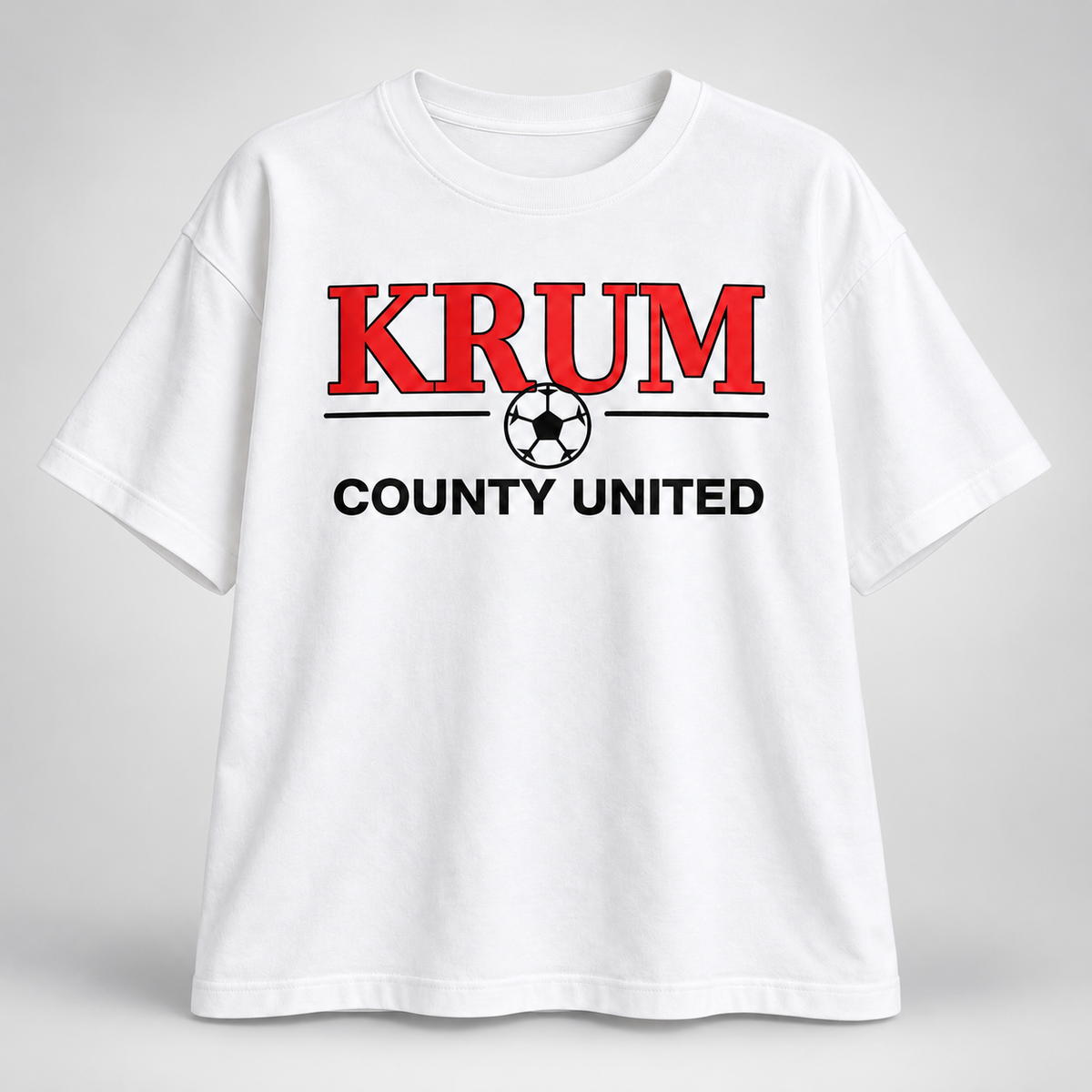 White women's relaxed T-shirt with red KRUM lettering, a soccer ball, and black County United text.