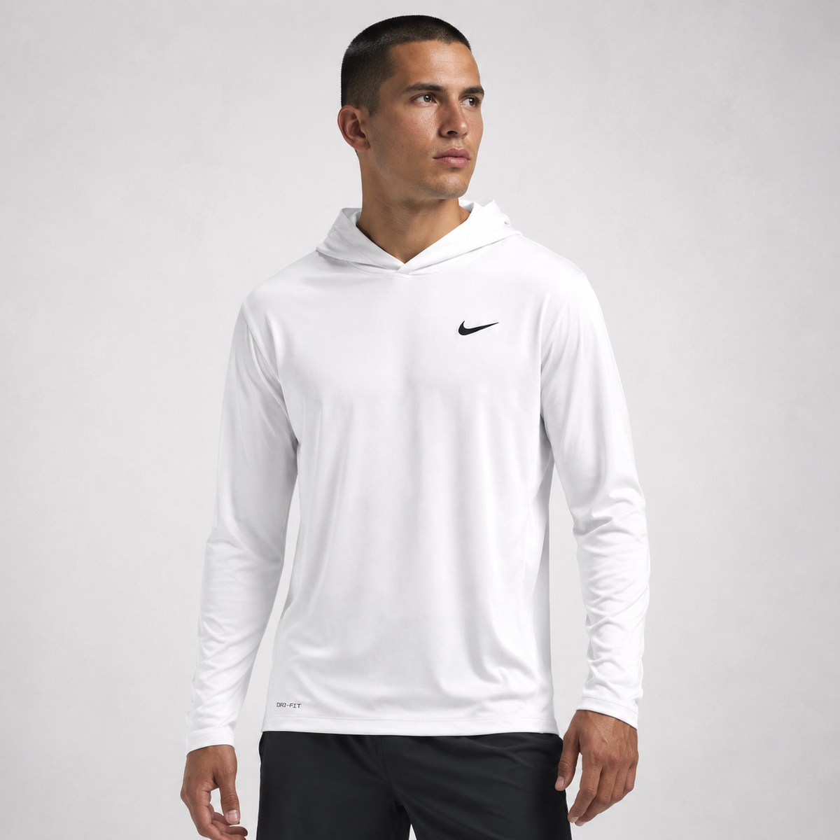 Athletic model wearing the Nike Men's Dri-Fit Long Sleeve Hoodie Tee