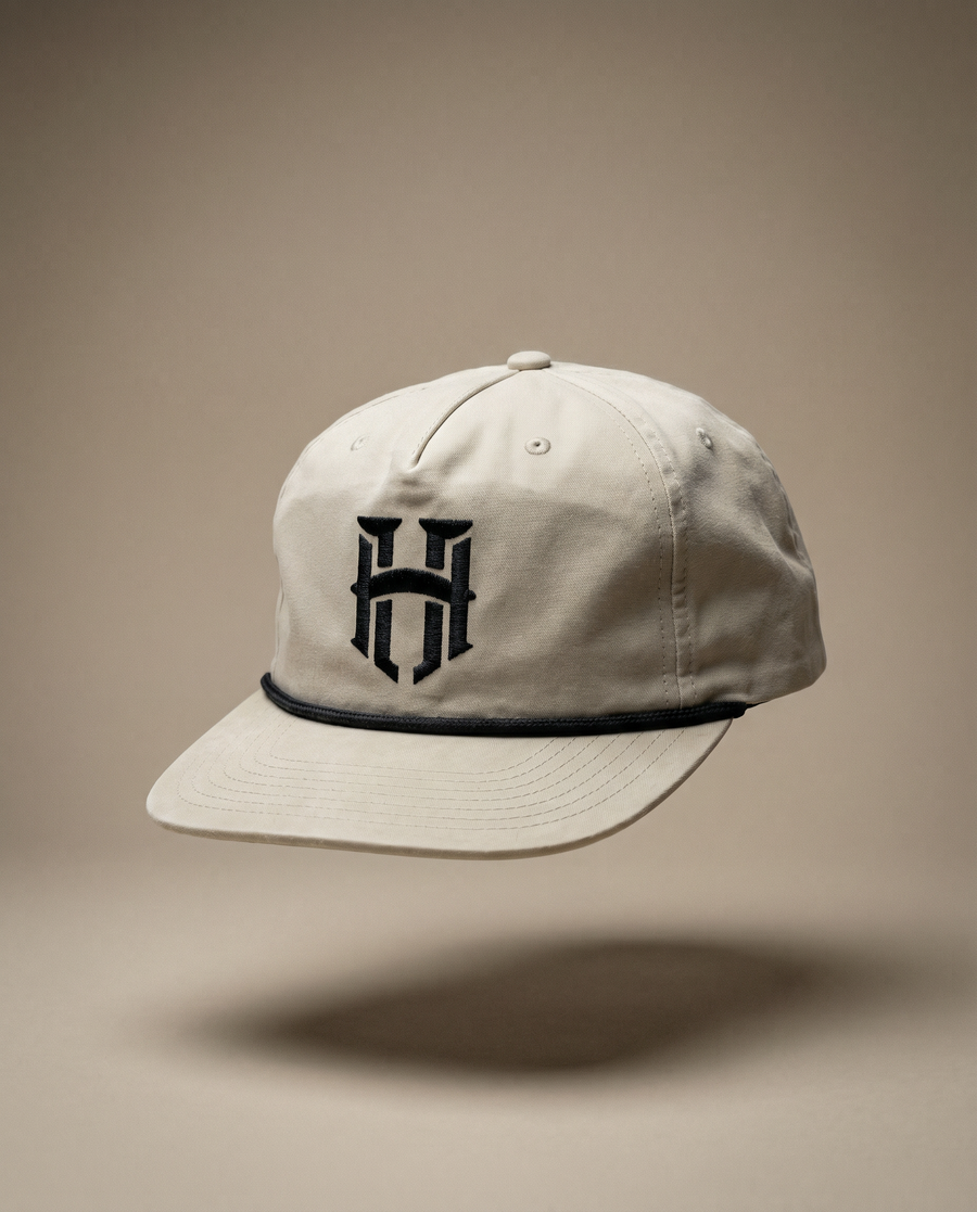 Beige cap with a black logo on a beige background