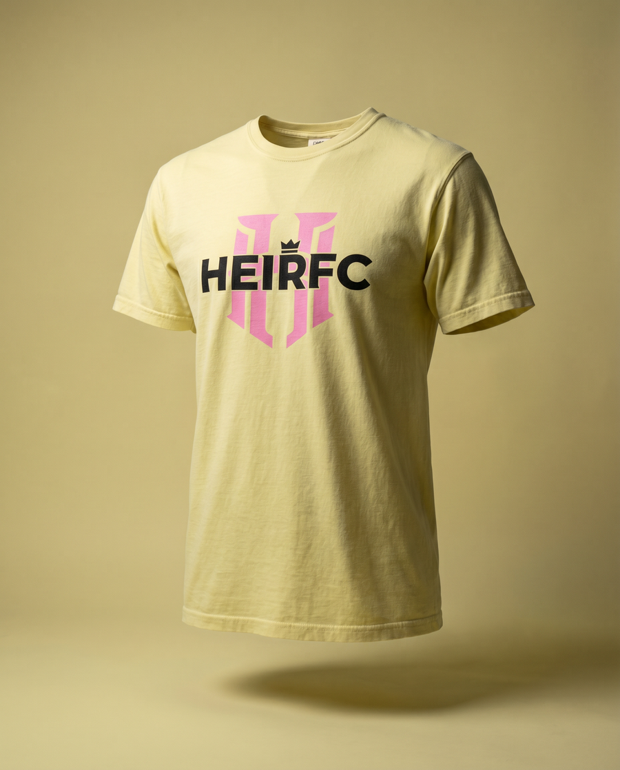 Yellow t-shirt with 'HEIRFC' logo on a beige background