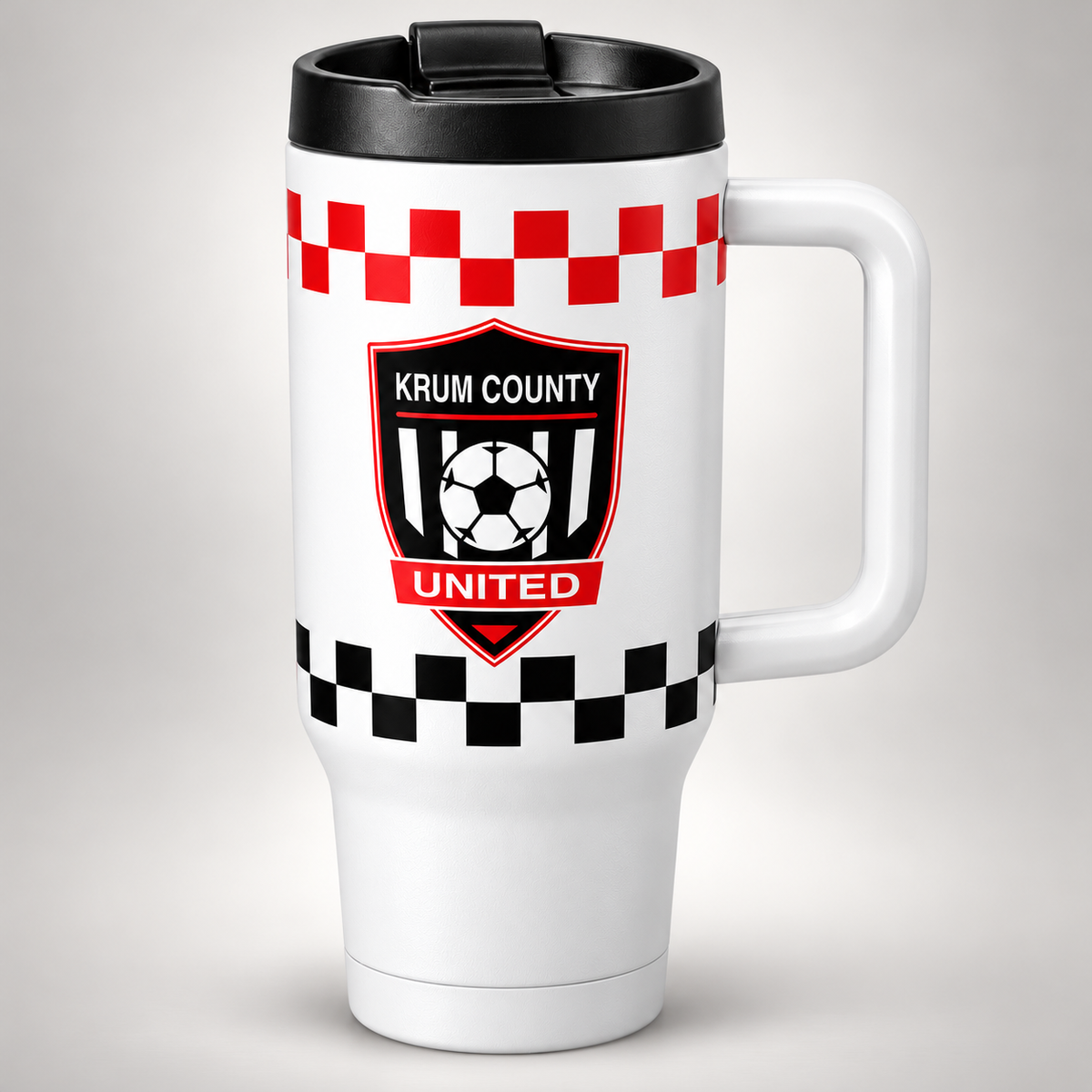 White handled Krum County United travel tumbler with a crest and red and black checker wrap bands.