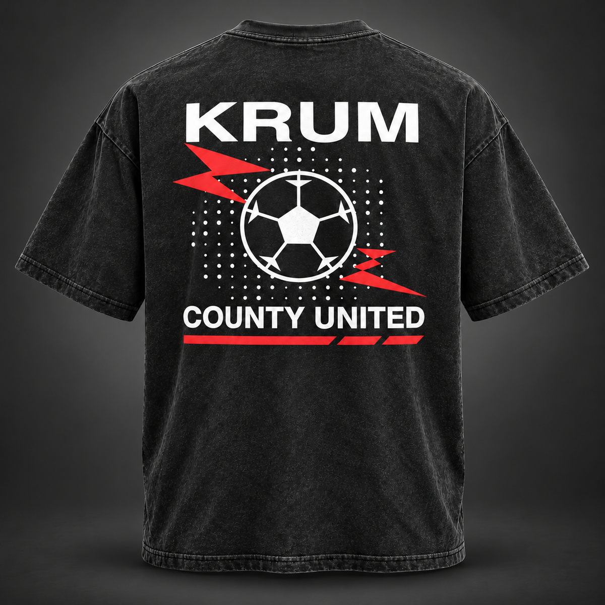 Back of the washed black Krum County United tee with a large red and white soccer-ball burst graphic.