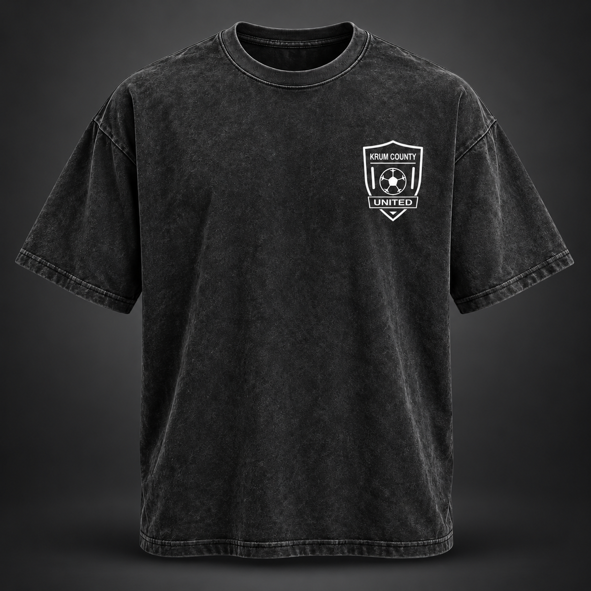 Washed black Krum County United oversized tee with a small white crest on the left chest.