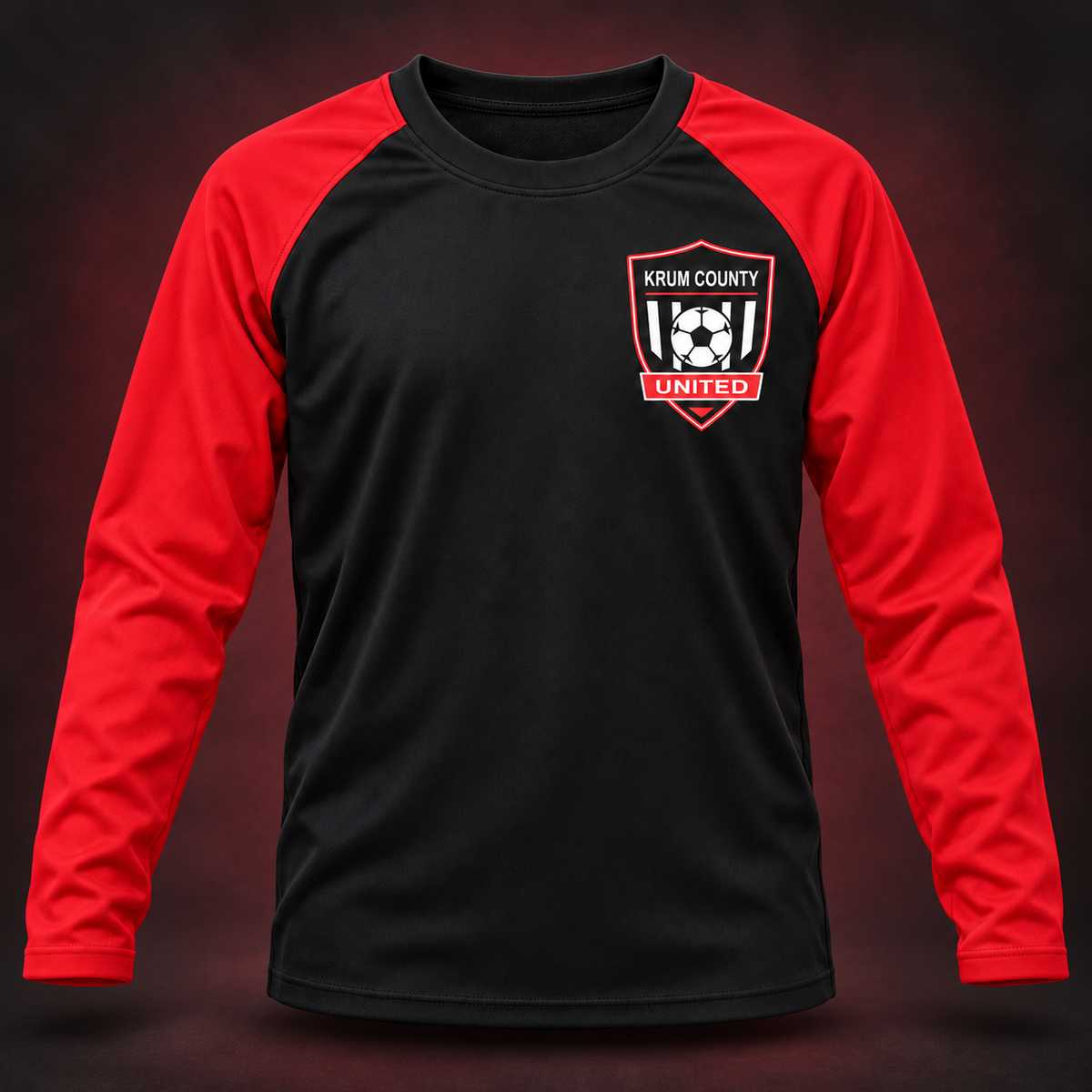 Black youth long-sleeve training top with red raglan sleeves and the Krum County United crest on the left chest.