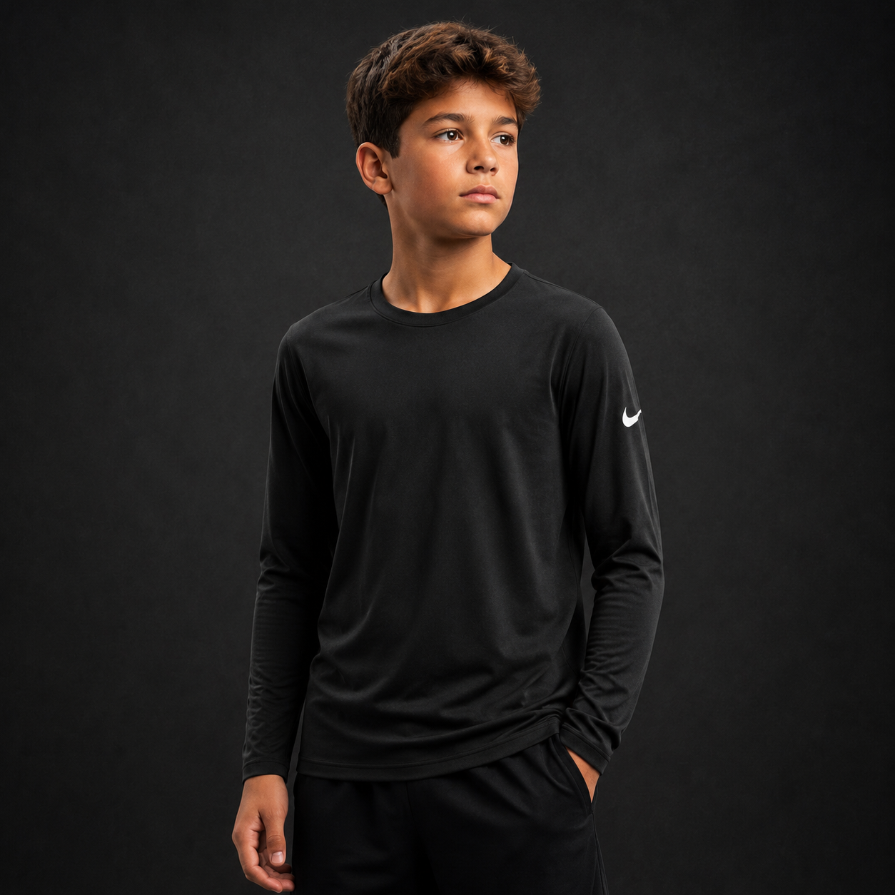 Youth athlete wearing the Nike Youth Long Sleeve Cotton Dri-Fit Shirt